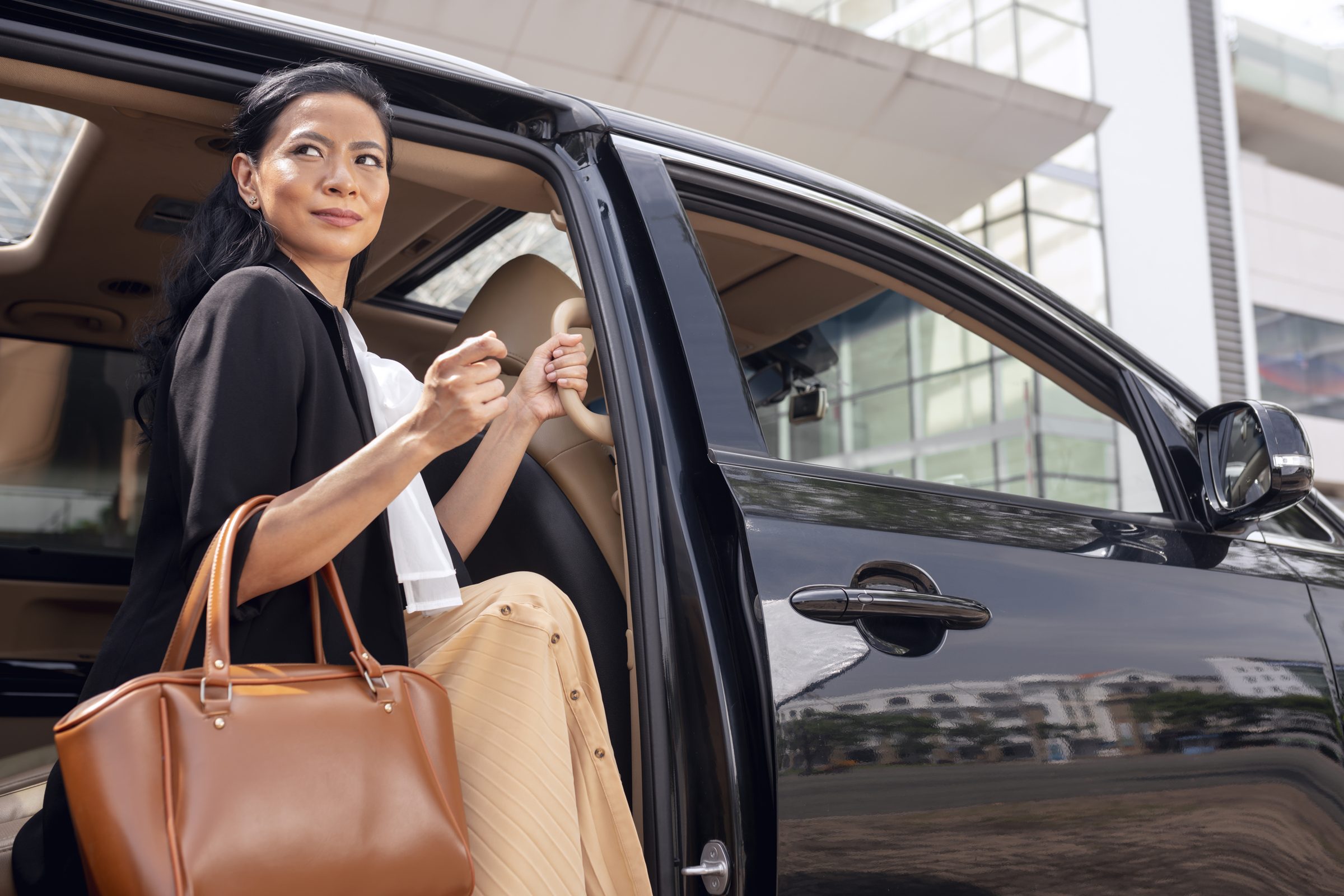 Businesswoman getting into car