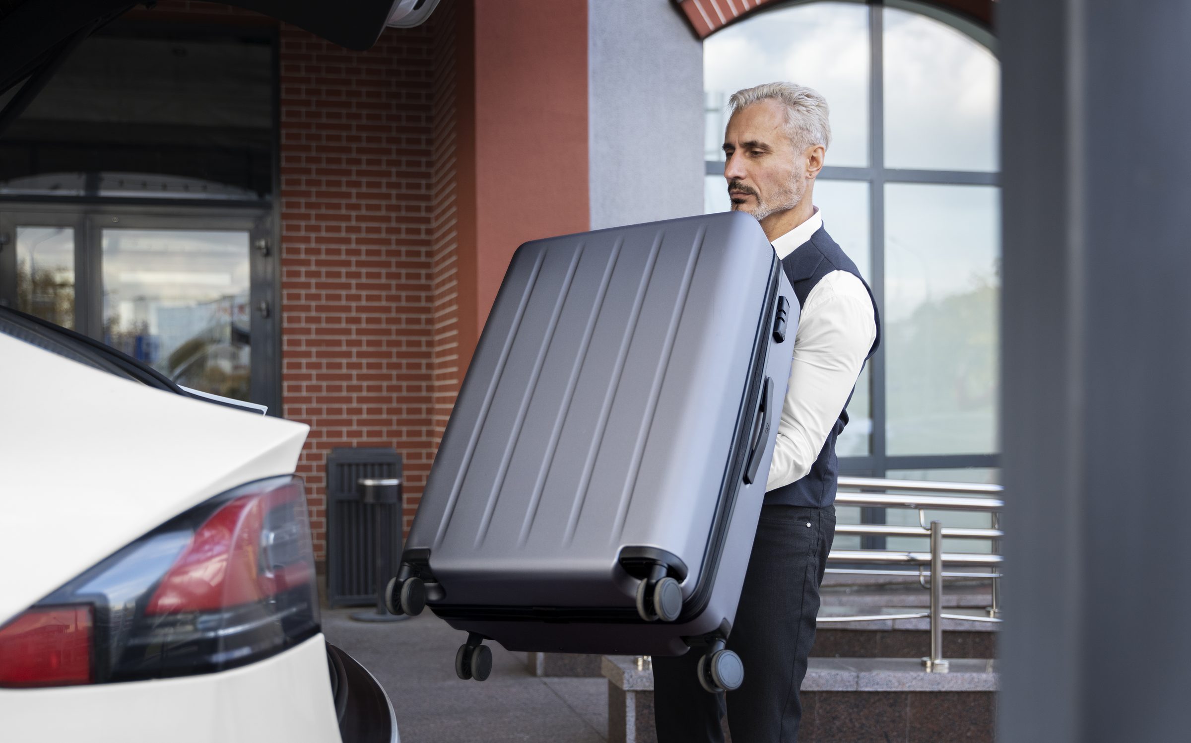 Driver carrying suitcase