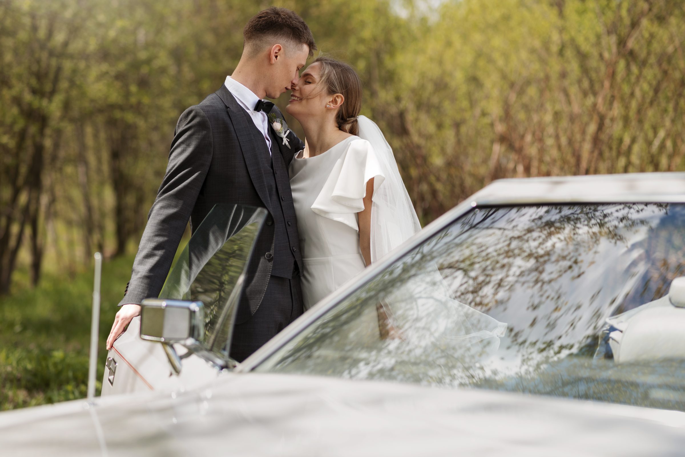 Wedding couple by car